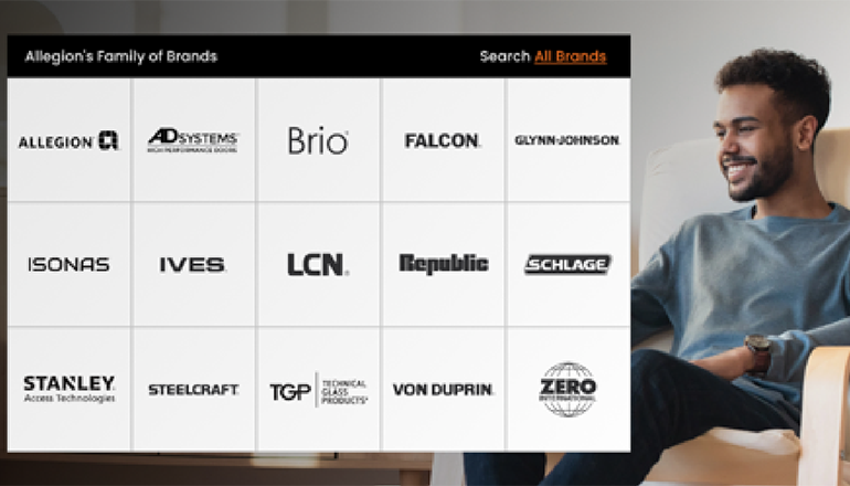 Smiling man using a laptop in a relaxed home setting with a backdrop featuring Allegion's family of brands, including Schlage and Von Duprin, displayed on a clear interface for easy brand navigation.